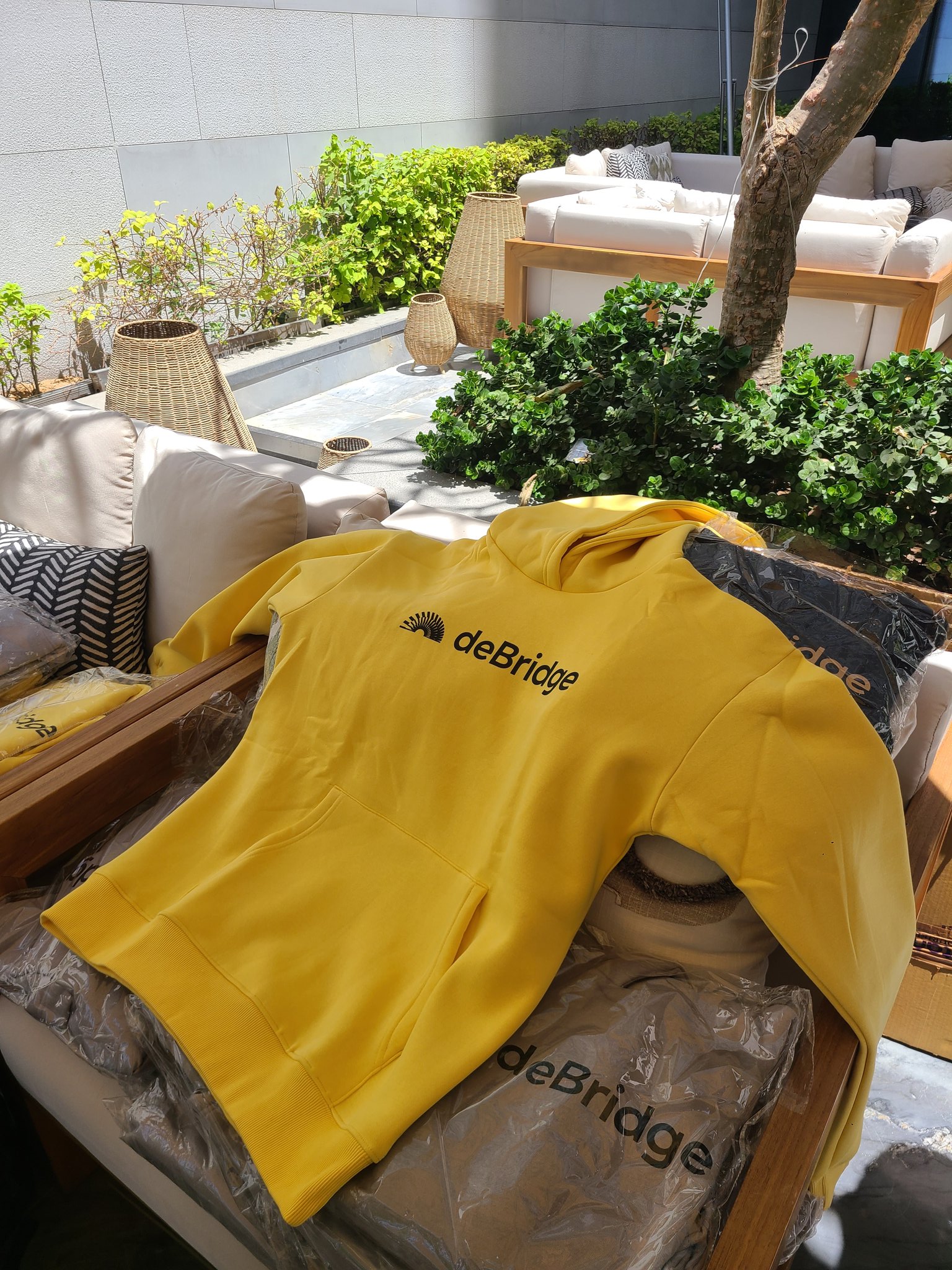 deBridge branded yellow hoodie
